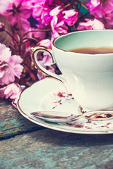 Beautiful, English, vintage teacup with Japanese cherry tree blossoms, close upt