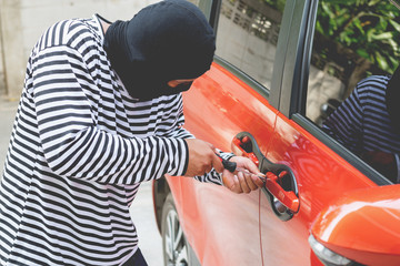 insurance safety concept : robber break lock door , thief man stealing women automobile