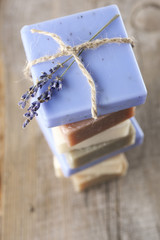 Assorted natural soap bars on wood