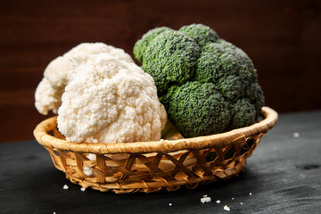 Green fresh broccoli with cauliflower on a dark wooden table