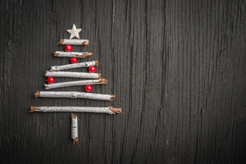 Creative Christmas tree made of branches and decorated with pearls
