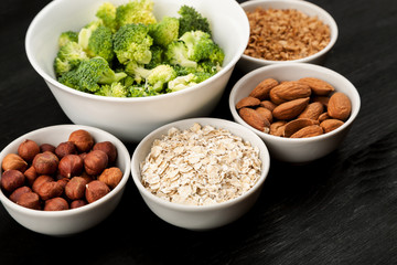 Cereals in a white ceramic dishes with different vegetables closeup shot