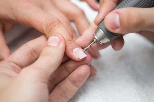 Manicure. The device removes the cuticle