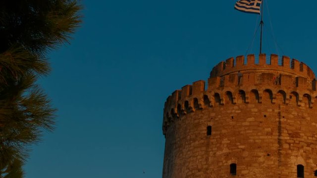Telephoto sunset golden hour shot of the White Tower, an icon of Thessaloniki, Greece. Its construction dates back to 1423. It is the second major political center of Greece