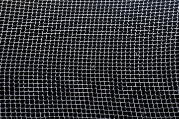 net of intertwined white rope / net protective in dark background