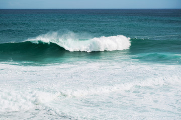 Fototapeta premium view from the beach to a tropical island and some granite rocks in the sea