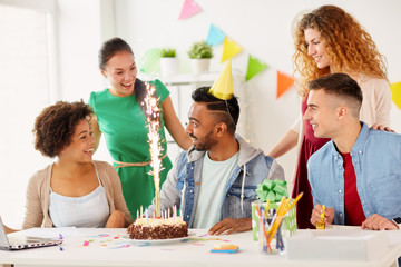 office team greeting colleague at birthday party