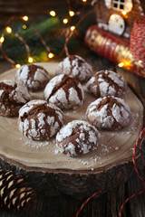Chocolate Crinkle Cookies in powdered sugar and Christmas decorations