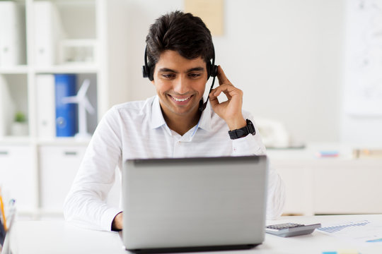 businessman with headset and laptop at office