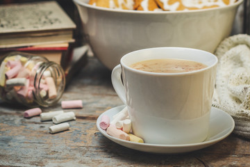 a mug of hot cocoa with cinnamon and reading books