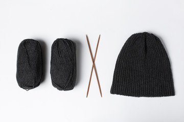 The hat is knitted in black with spokes