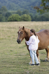 Naklejka premium Teenager with Horses in a meadow