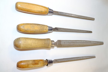 tools for work, round, triangular, square files rasp with wooden handles on a white background