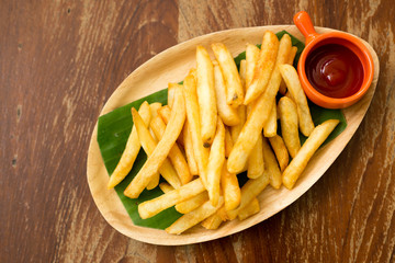 French fries with tomato ketchup on wood