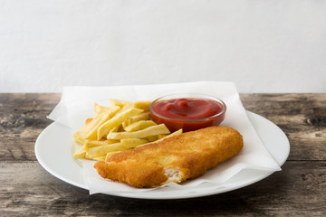 Traditional British fish and chips on wooden table. Copyspace
