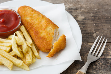 Traditional British fish and chips on wooden table. Copyspace