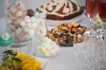 modern stylish luxury wedding candy bar. a wide range of sweets on a wedding candy bar.