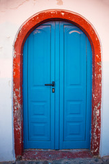 Shabby blue door Santorini Island in Greece