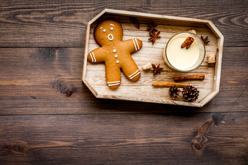 Eggnog for christmas evening. Two glasses near gignerbread cookie on dark wooden background top view copyspace