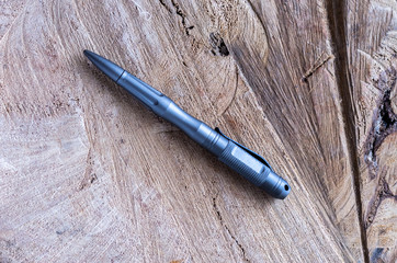 Gray metal handle for self-defense. Ballpoint pen made of metal.