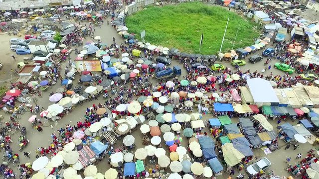 Tilt up aerial, crowded Douala streets