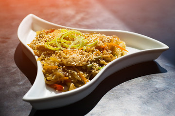 Asian food. A close-up of Chinese udon noodles with curry chicken.