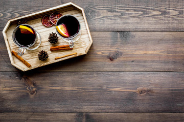 Winter tea with citrus and spices on dark wooden background top view copyspace