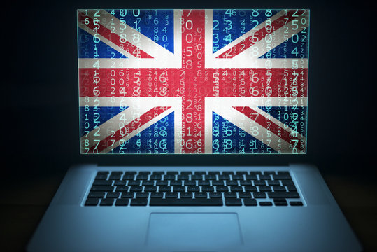 English hacker. Laptop with binary computer code and UK flag on the screen. Internet and network security. 