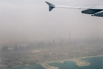 Fototapeta premium The plane-the view from the window of the porthole on the city Arab Emirates Dubai