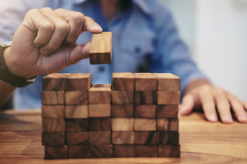 Alternative risk concept, plan and strategy in business, Risk To Make Business Growth Concept With Wooden Blocks, hand of man has piling up a wooden block