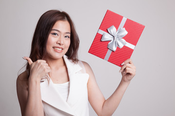 Young Asian woman thumbs up with a gift box.