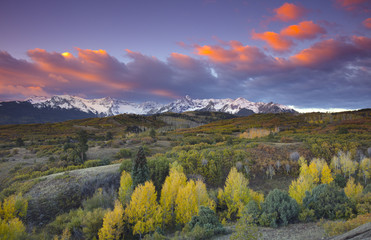 Sunset over view of San Juan Mountains and Autumn Fall color aspen trees of the Dallas Divide Mountains Ridgway, Colorado, America