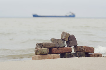 old bricks on the sea shore