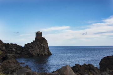 ancient watchtower in lava stone in Sicily