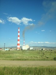 Fototapeta na wymiar Thermal power plant in the green field on sunny day