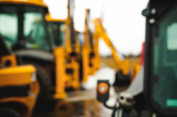 Excavator Loader Machine. Side View of Front Hoe Loader. Industrial Vehicle. Heavy Equipment Machine. Pneumatic Truck. Construction Equipment. abstract background blur