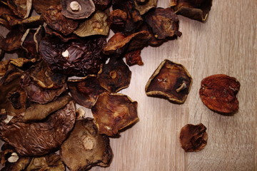 Dried edible mushrooms harvested in forest on wooden table
