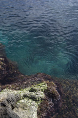 detail of Sicilian rock coast with crystalline sea