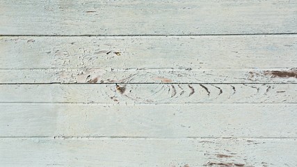 Cracking and peeling paint on a wood wall