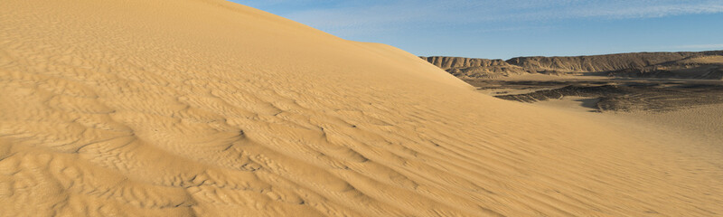 Fototapeta na wymiar By wind shaped dunes in the White desert