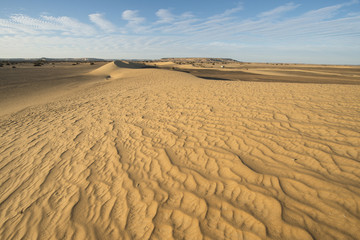 By wind shaped dunes in the White desert