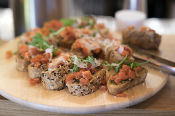 Bruschetta with tomato and cheese on a plate