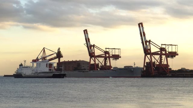 Evening port, cranes and ship - video 4K UHD
