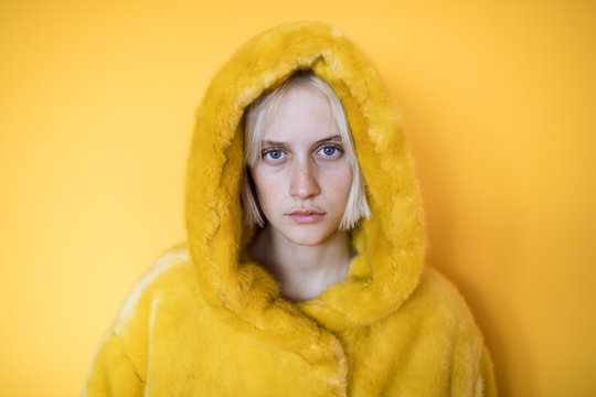 Portrait of woman in plush yellow coat