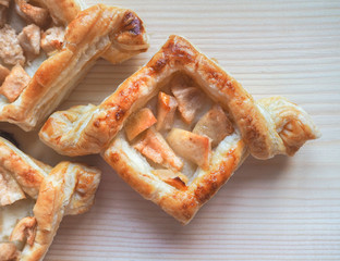 Turnovers of puff pastry with apple and pear. Puff pie.

