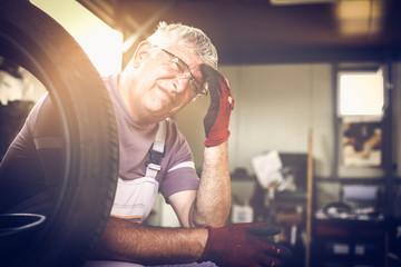  Man having headache after hard work. Senior