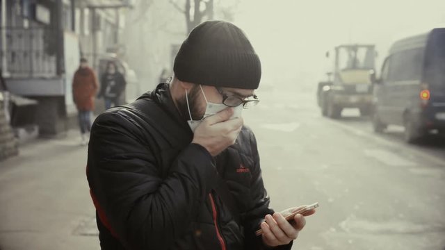A man wearing a mask on the street. Protection against virus and grip