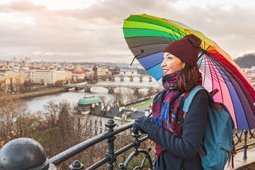 Fototapeta premium Girl walking with umbrella on rainy day in historical center of Prague, Europe