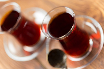Red tea in turkish glasses on a wooden table