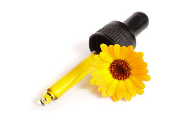 aromatherapy essential oil with marigold flowers isolated white background